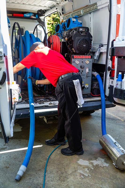 Vince winding water hose into van