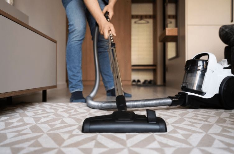  A picture of a person vacuuming a carpet