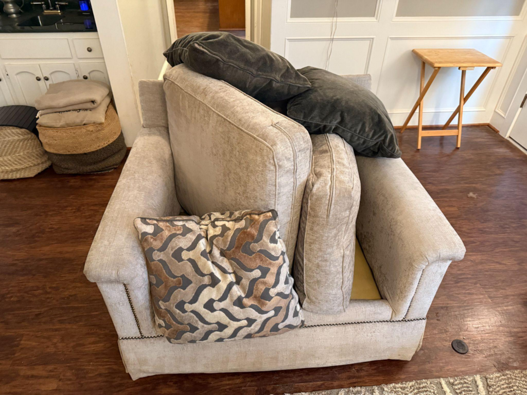 This photo shows a disheveled sofa in the middle of a room