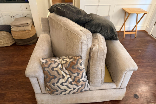 This photo shows a disheveled sofa in the middle of a room