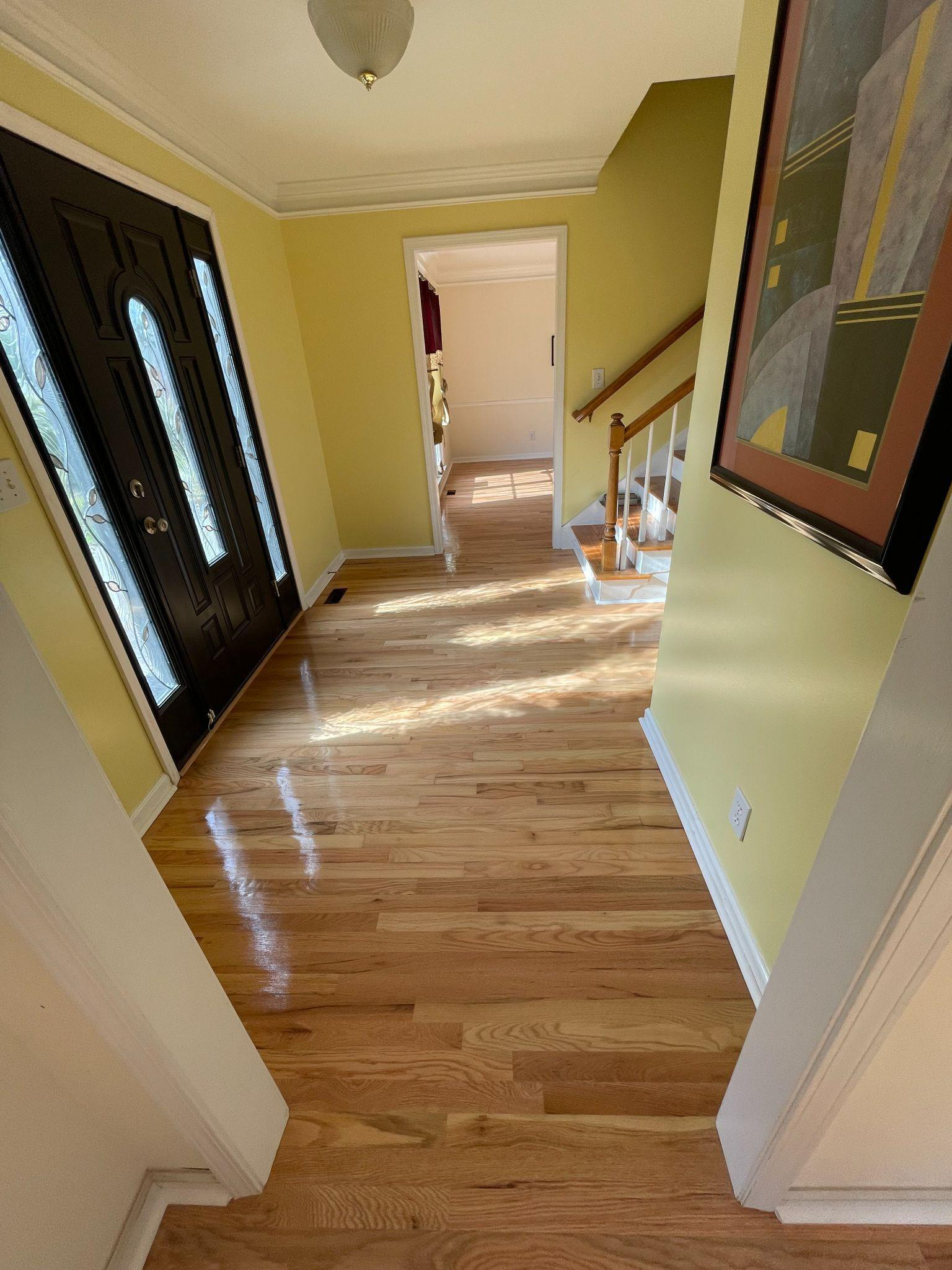 This photo shows a room with hardwood flooring