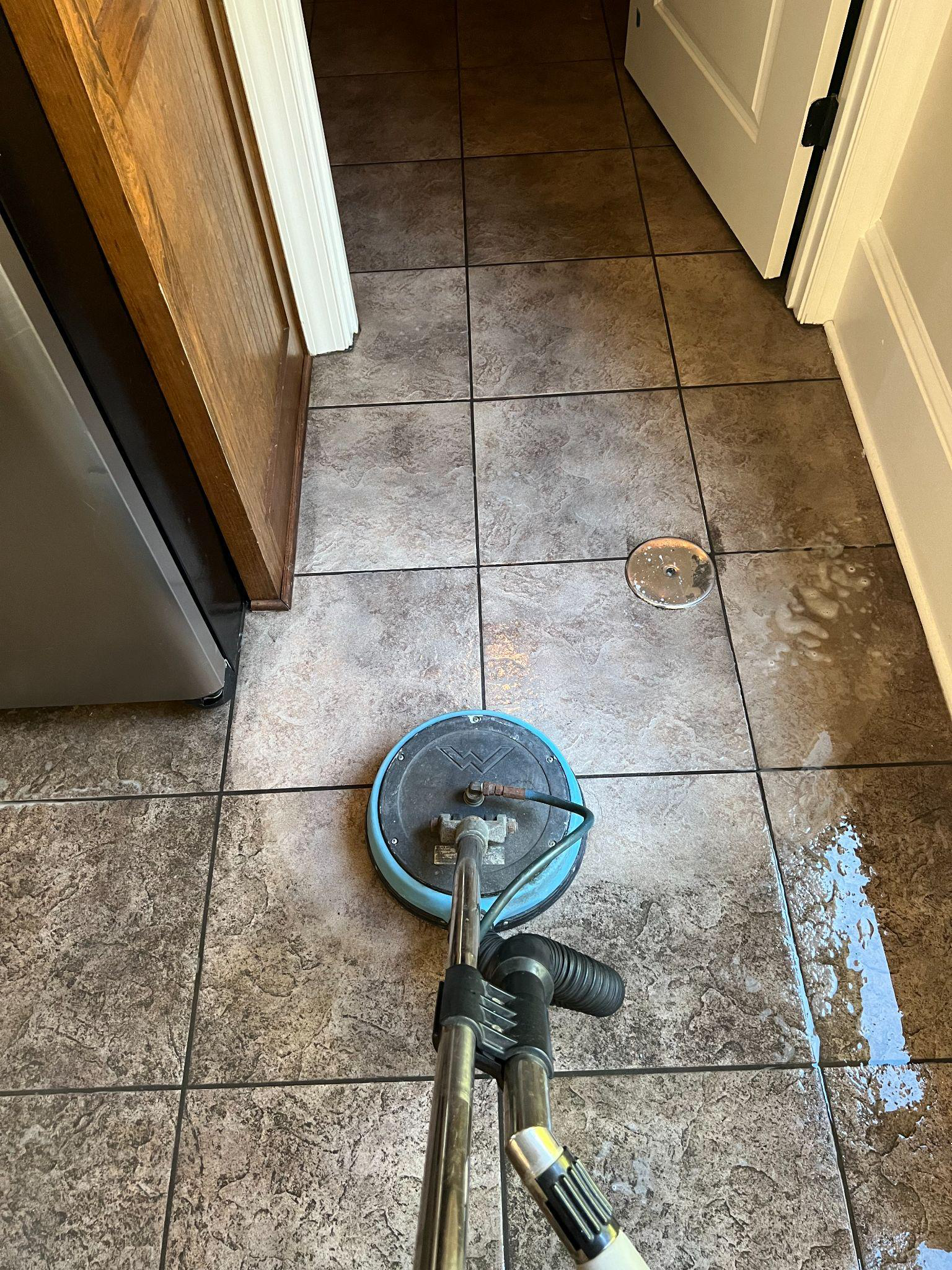 This photo shows a tiled floor being cleaned