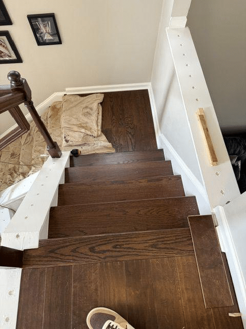 This photo shows flooring being installed on a staircase