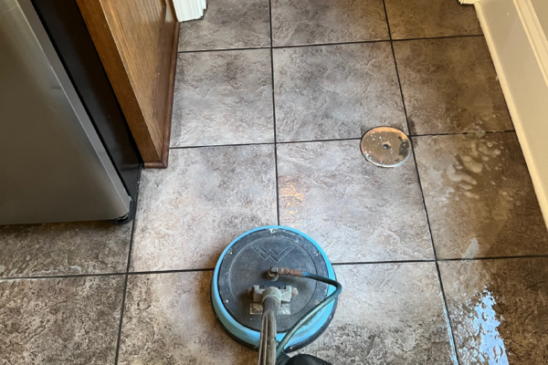 A machine being used to deep-clean the tile surface
