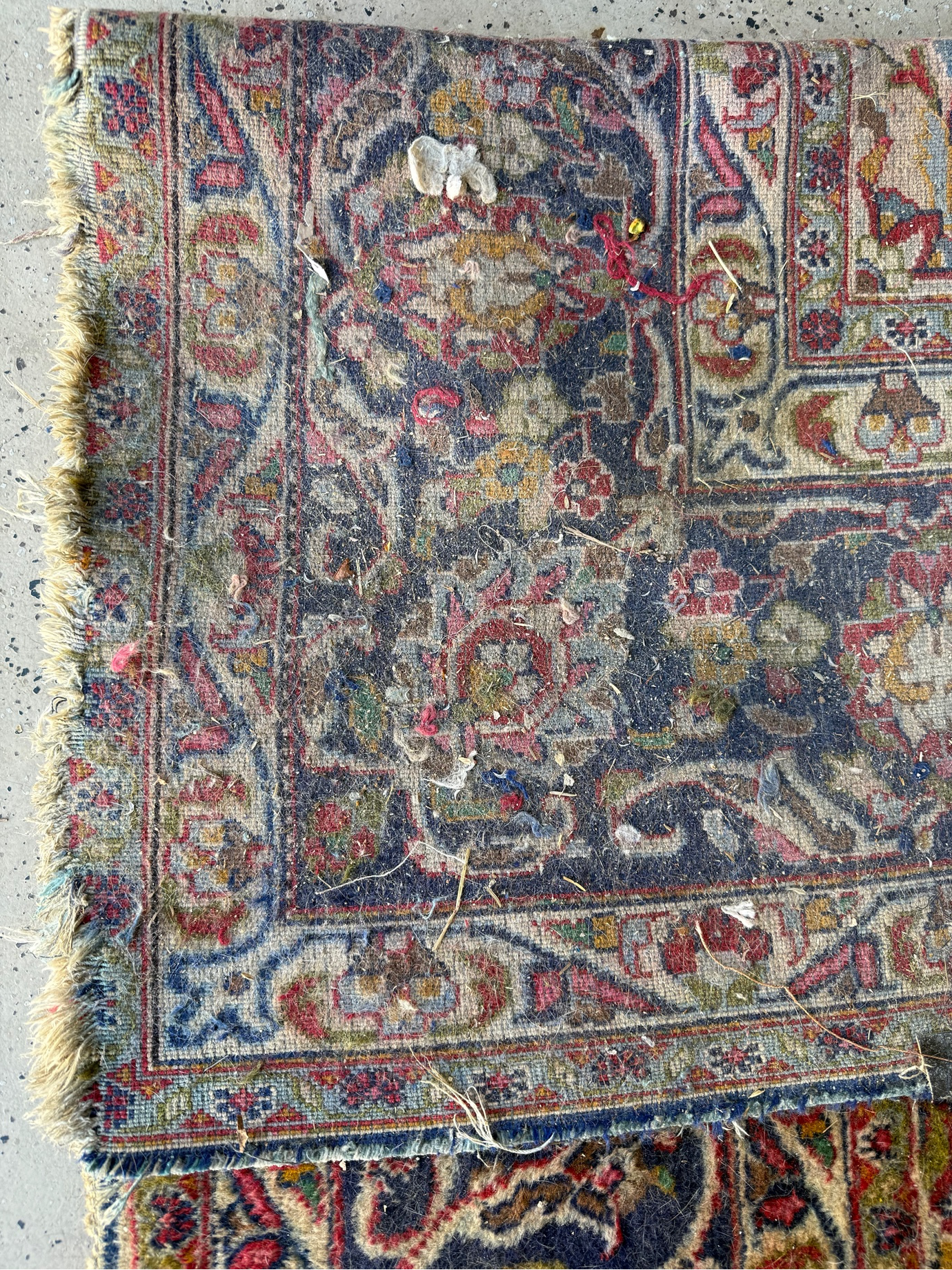 A piece of carpet in need of repair